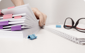 womens-hands-sort-through-papers-with-information-business-conceptcopy-space 1-min